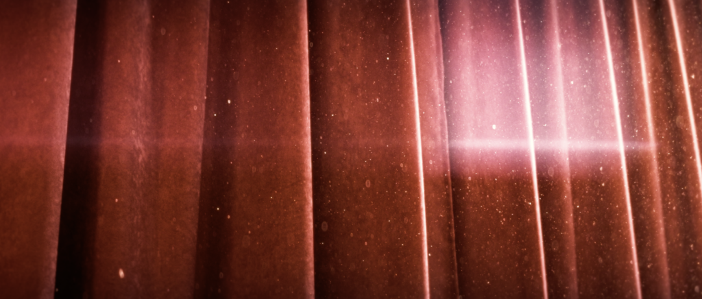 Dust flying in front of a red curtain with light beautifully hitting everything
